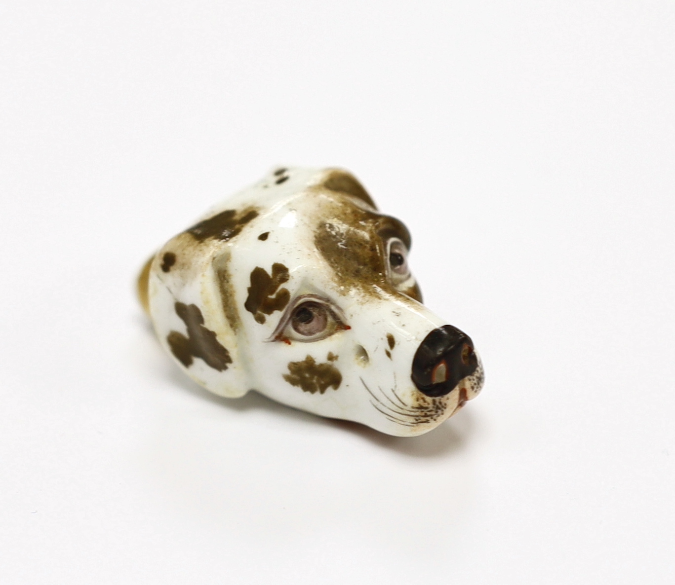 An early 19th century Staffordshire porcelain dog’s head whistle, 4.5cm